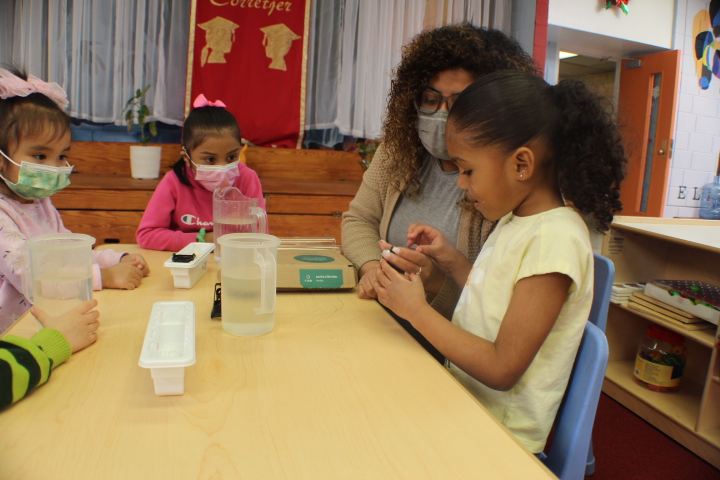 Young learners working together at a low table